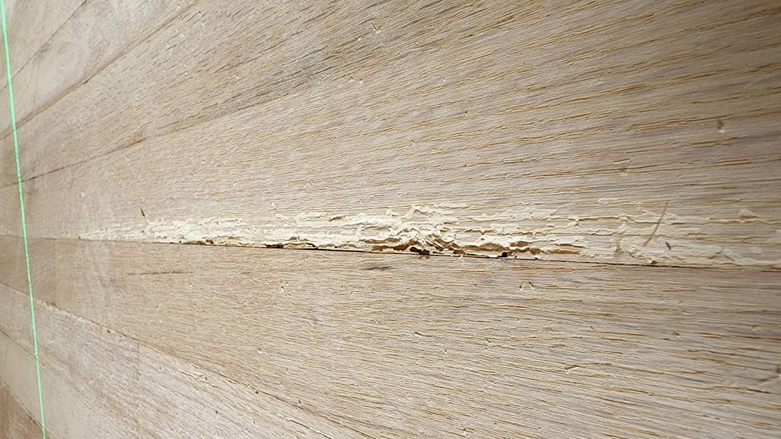 Wooden floor with a noticeable crack running through it.