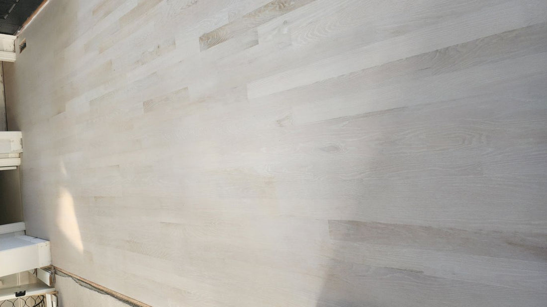 Light-colored wooden flooring in an unfinished interior space.