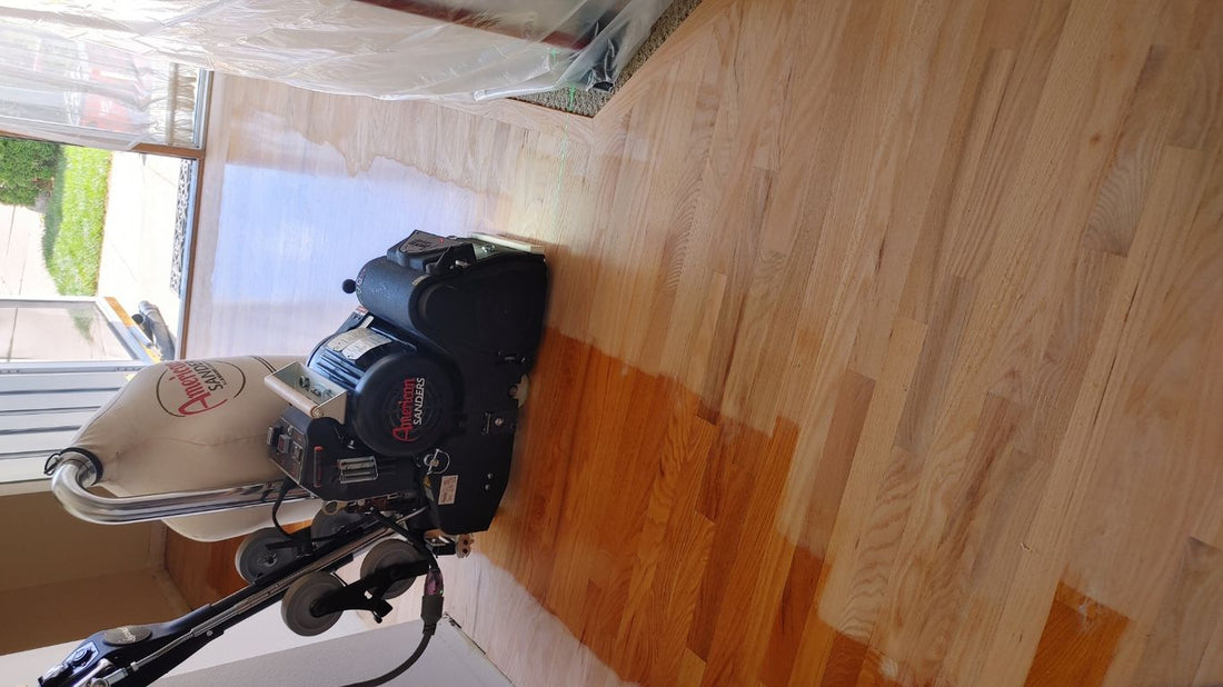 Wood floor being refinished with equipment in a home.