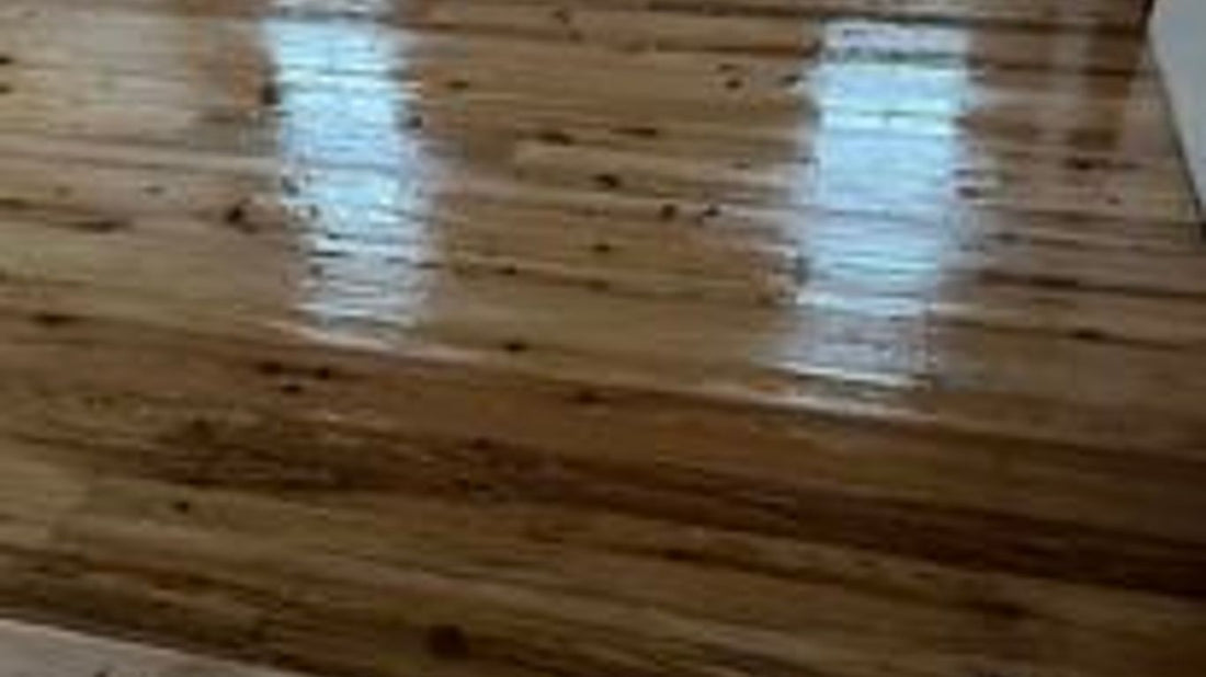 A polished wooden floor with natural light reflections.